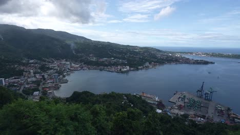 Landscape-of-residential-area,-port-and-container-ship,-bridge-around-gulf-in-Jayapura-City,-Papua,-Indonesia