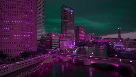 Tampa-skyline,-pink-and-green-hues-at-night-along-the-Hillsborough-River