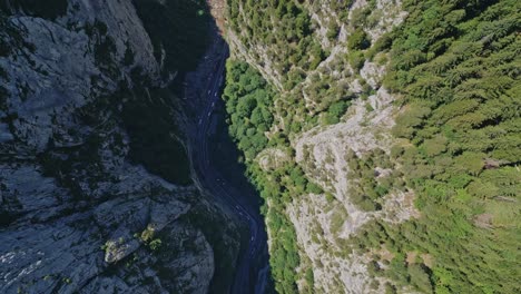 downward-aerial-of-Bicaz-Chei-mountain-river-valley,-Bicaz-Gorge,-running-mountain-stream-where-tourists-stop-to-take-in-the-breathtaking-views-in-Romania