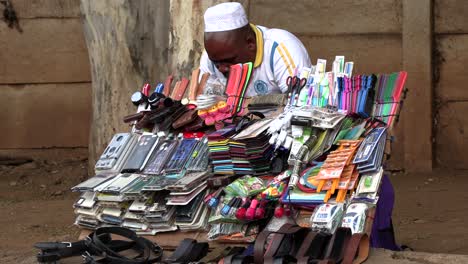 A-display-board-with-all-kinds-of-trinkets-forms-the-shop-of-a-local-indigenous-African-man