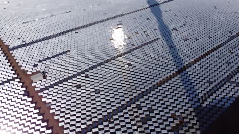 A-tilt-down-shot-of-a-solar-farm-with-thousands-of-heliostat-mirrors-reflecting-sunlight