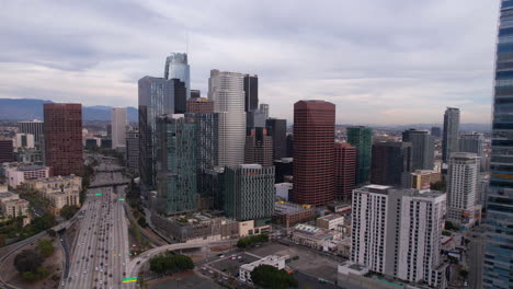 Downtown-Los-Angeles-USA,-Drone-Shot-of-Central-Towers-and-Traffic-on-State-110-Highway,-California