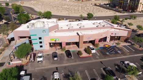 Cinematic-Establishing-Drone-Shot-Above-Strip-Mall-in-Desert-Landscape