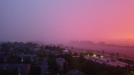 High-altitude-aerial-view-from-a-foggy-weather-somewhere-in-Montréal's-waterside,-Canada