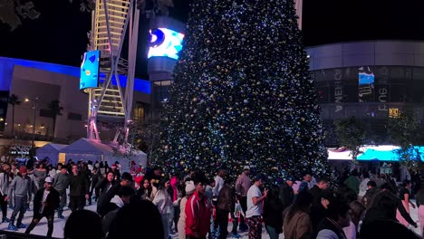 LA-Kings-Holiday-Ice-Rink-and-People-Skating-Around-Big-Christmas-Tree,-Los-Angeles,-California-USA