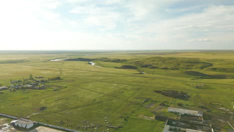 A-Broad-View-of-Green-Fields,-Houses,-and-a-River-in-the-Rural-Region-of-Kazakhstan,-Central-Asia---Aerial-Drone-Shot