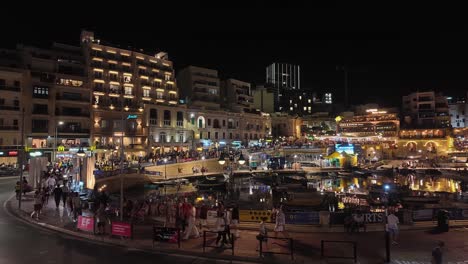 English-and-Spanish-football-fans-leave-the-public-screen-after-the-Euro-Cup-2024-final-match-in-the-center-of-St-Julian's-at-night,-Malta