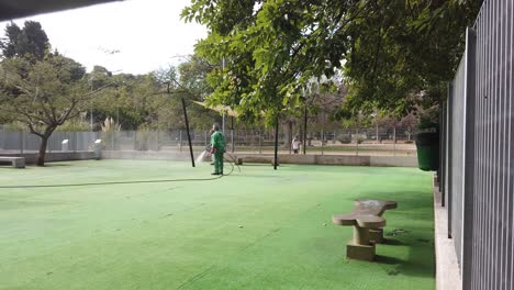 Artificial-grass-landscape-with-cleaners,-workers-at-dog-urban-park-in-buenos-aires-city-argentina