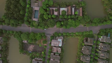 Car-driving-through-rural-Hanoi,-aerial-top-down-Vietnam