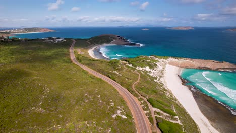 4K-drone-video-of-a-stunning-long-road-next-to-a-beautiful-beach-in-Esperance,-Western-Australia