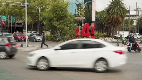 Vehicles-drive-and-stop-on-crossroads-of-Paseo-de-la-Reforma-and-Bucareli-Avenue-in-Mexico-City