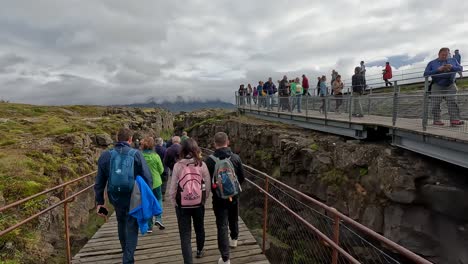 Tourists-coming-down-from-an-overlook-in-Thingvellir-National-Park,-Iceland