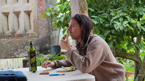 European-nordic-man-tasting-a-toast-with-avocado-in-the-garden