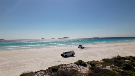 4K-drone-video-of-a-camper-van-driving-on-Le-Grand-Beach-in-the-Cape-Le-Grand-National-Park,-Western-Australia