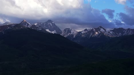 Capital-Peak-Old-Mount-Snowmass-Resort-Colorado-aerial-drone-dark-clouds-sunset-Mt-Sopris-Sopras-Maroon-Bells-Aspen-Wilderness-summer-June-July-Rocky-Mountains-peaks-National-Forest-backwards-pan-up