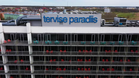 4-star-Tervise-Paradiis-Spa-Hotel-in-Parnu-with-blue-logo,-drone-view-backwards