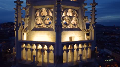 Votivkirche-church-tower-in-Vienna,-Austria-at-dusk-with-interior-lighting