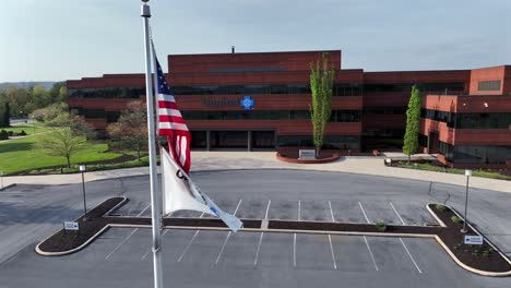 American-flag-on-parking-lot-of-Capital-Blue-Cross,-Corporate-Headquarters-in-Harrisburg-Town,-USA