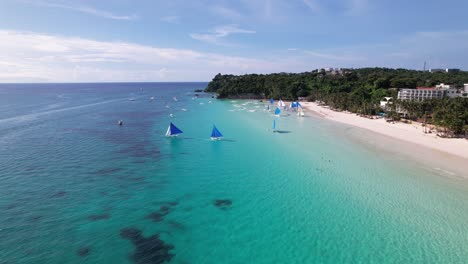 Boracay-beach-in-the-philippines-shot-from-a-drone-capturing-the-beautiful-sail-boats,-beach-and-people-enjoying-paradise