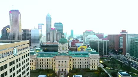 Forward-drone-flight-over-the-West-downtown-on-a-cloudy-bright-day-in-America,-Indianapolis-in-slow-motion-and-with-copy-space