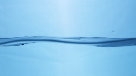 Slow-motion-of-Water-waves-on-surface-with-blue-background