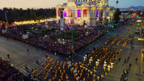 Aerial-view-of-mass-gathering-on-Day-of-the-Dead-Parade-in-Palacio-de-Bellas-Artes-of-Mexico-City-street-in-the-evening