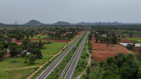 Aerial-footage-capturing-the-highway-and-an-adjacent-railway-track-running-parallel