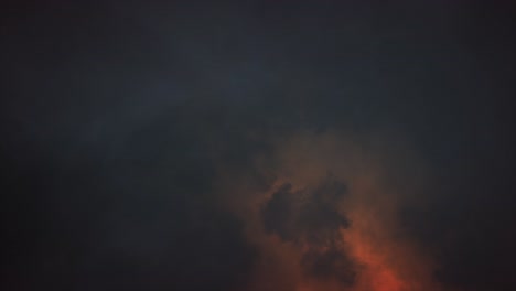 Cloud-Lightning---Eerie-spectacular-and-dramatic-lightening-storm-illuminating-the-inside-of-dark-and-sullen-clouds-with-brilliant-and-intense-bolts-and-flashes-of-orange-lightning