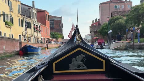 Inside-View-Of-A-Traditional-Gondola-Boat-Cruising-Through-A-Waterway-Canal-In-Venice,-Italy