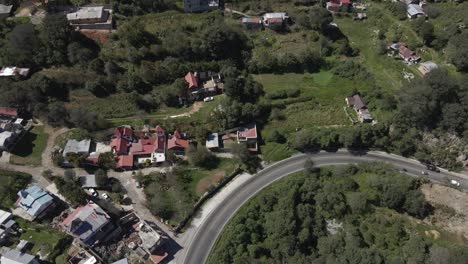 Huasteca-Potosina-Bernal-rural-village-panoramic-aerial,-curved-road,-Mexico