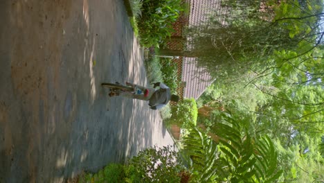 Vertical-View-Of-An-Active-African-Boy-Riding-His-Bike-In-The-Park-In-Africa