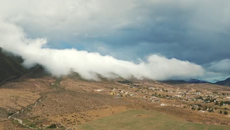 Epic-low-clouds-on-mountains-and-fields-of-the-Province-of-Tucuman-in-Argentina,-slow-motion-and-copy-space