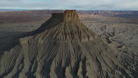 Aerial-View-of-Moonlike-Landscape,-Gray-Sandstone-Badlands-and-Factory-Butte,-Utah-USA