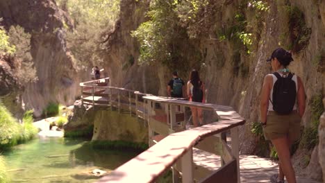 Hiking-though-wooden-bridge-over-river-and-mountain-in-Cazorla,-Spain