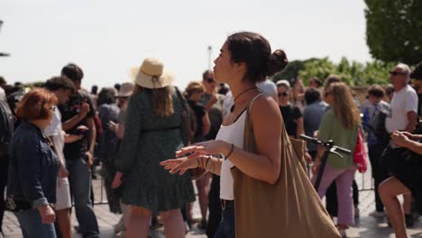 Slow-motion-shot-of-a-woman-dancing-in-the-crowd-at-the-Olympic-torch-relay