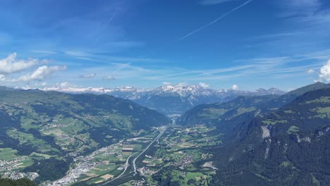 Hiker-on-bench-in-top-of-mountain-with-river-and-small-town-in-the-valley