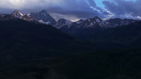 Capital-Peak-Old-Mount-Snowmass-Resort-Colorado-aerial-drone-forward-pan-up-dark-clouds-sunset-Mt-Sopris-Sopras-Maroon-Bells-Aspen-Wilderness-summer-June-July-Rocky-Mountains-peaks-National-Forest