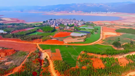 Overhead-natural-panoramic-large-agricultural-lands-with-corn,-wheat-and-terrace-farming-fields-in-rural-at-mountain-near-small-village