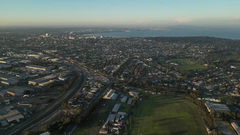 Geelong-city-with-coast-in-background-at-sunset,-Corio-Bay-close-to-Melbourne,-Victoria-state-in-Australia