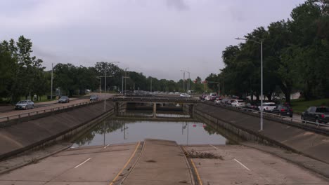 Drone-view-of-under-bridge-flooding-on-Allen-Parkway-in-Houston,-Texas