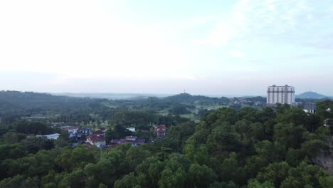 Slow-straight-panning-shot-above-forest-reserve-at-midday-in-Malaysia