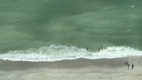 Group-of-young-people-and-family-swimming-at-the-edge-of-the-shore-at-Myrtle-Beach