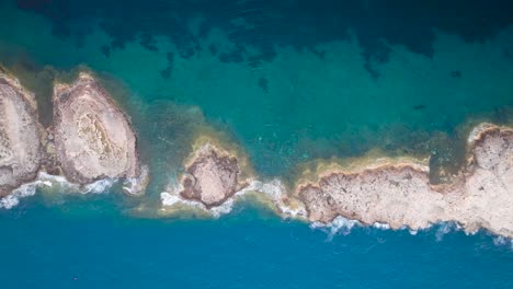 Aerial-top-down-view-of-Punta-de-El-Toro-limestone-path-in-sea,-Mallorca