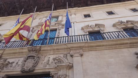 Spanish,-Catalunian-and-European-flag-on-display-at-Palma-mayor-town-hall,-Spain