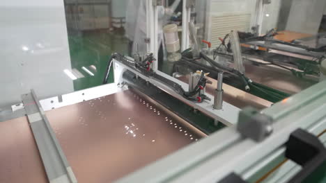 Close-up-Electronics-and-Circuit-board-Manufacturing-Factory-industrial-dust-free-workshop-of-chip-factory,-While-board-moving-on-assembly-line