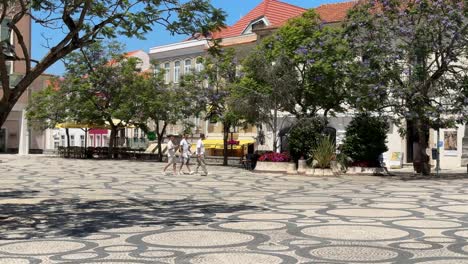 People-walking-on-beautiful-Portuguese-pavement-in-Aveiro,-Portugal