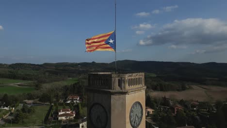 Standbild-Einer-Katalanischen-Unabhängigkeitsflagge,-Die-In-Zeitlupe-Oben-Auf-Einem-Uhrturm-Im-Wind-Flattert