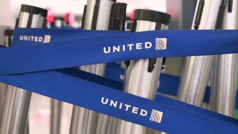 The-logo-of-United-Airlines,-an-American-airline,-is-seen-on-barrier-tapes-at-Chek-Lap-Kok-Hong-Kong-International-Airport