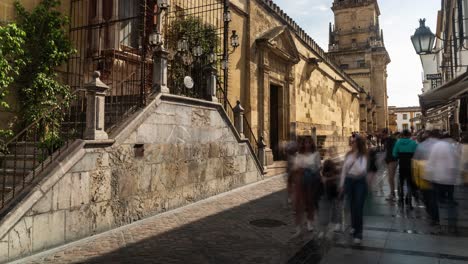 Motionlapse-footage-of-tourists-walking-through-the-streets-of-Córdoba,-Spain,-beside-the-historic-Mosque-Cathedral