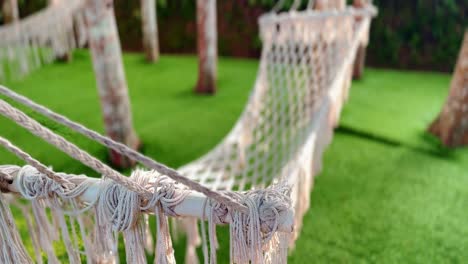 Empty-white-hammocks-hanging-between-trees